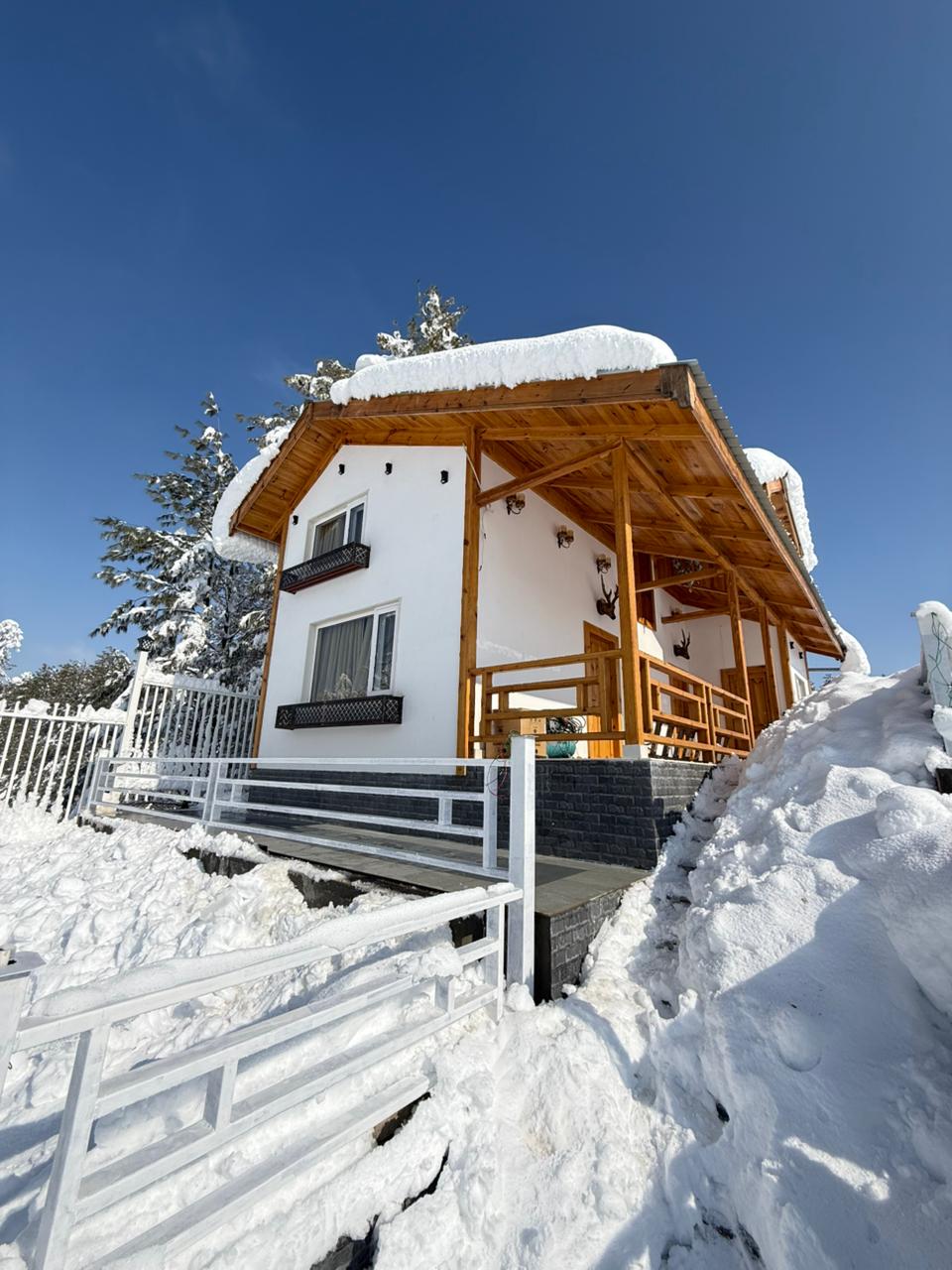 Doodhpathri Meadow's Doodhpathri luxury duplex cottage exterior view with mountain backdrop