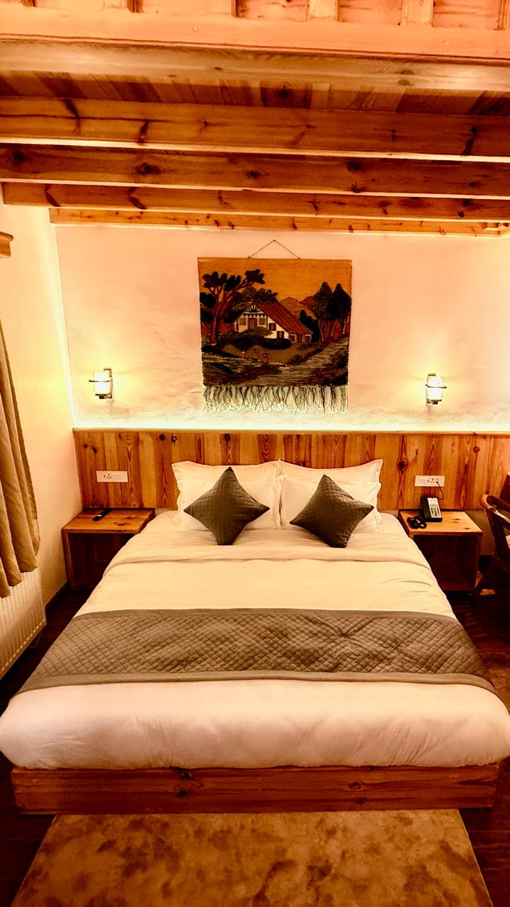 Bedroom setup with mountain view at Doodhpathri Meadow's Doodhpathri